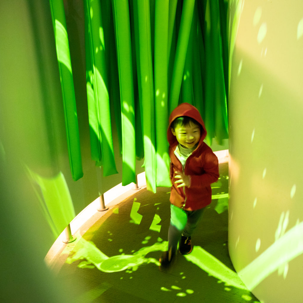 Boy running through virtual slime in the Art and Tech exhibit