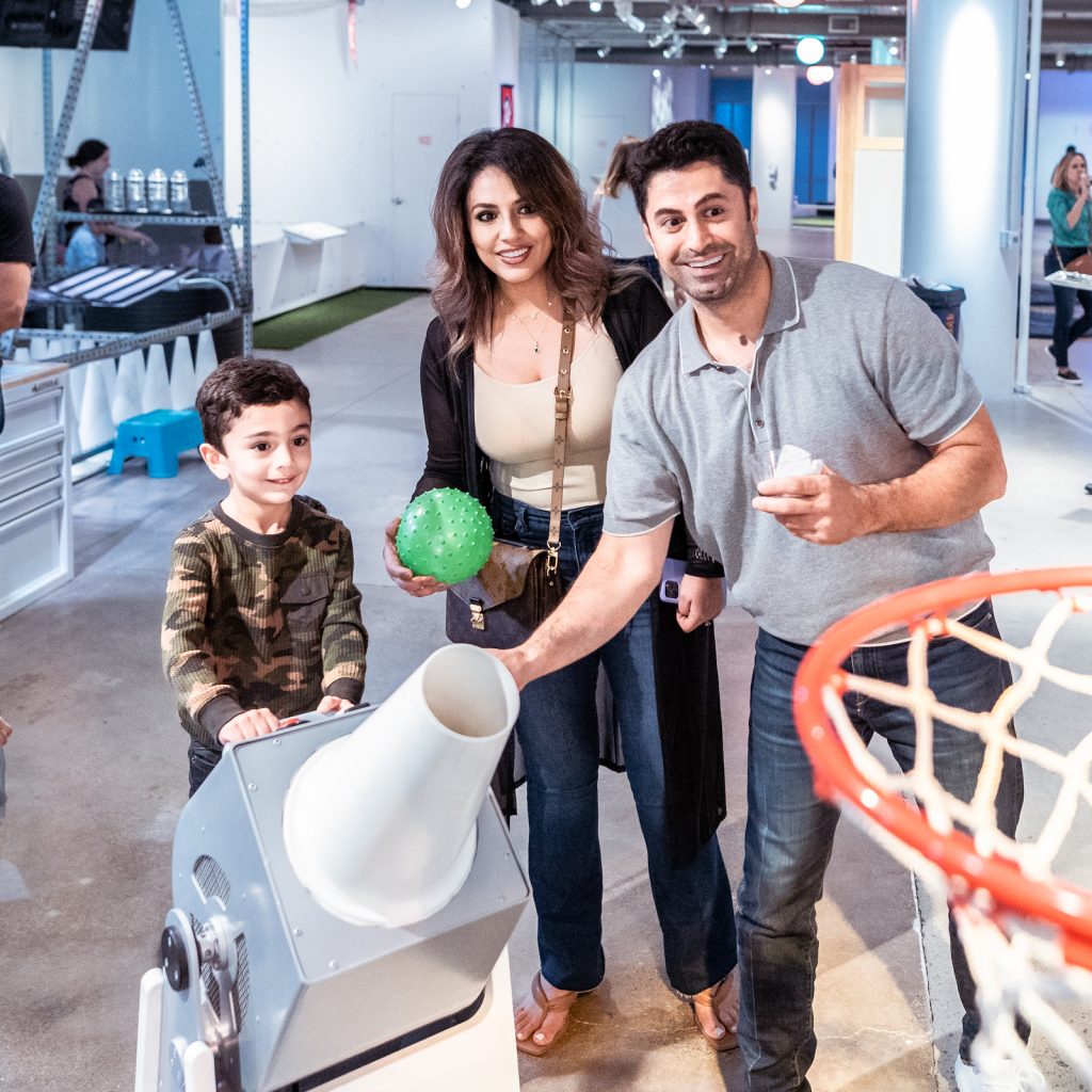 Family at the Bernoulli's Hoops experience in the Engineering Games + Play exhibit
