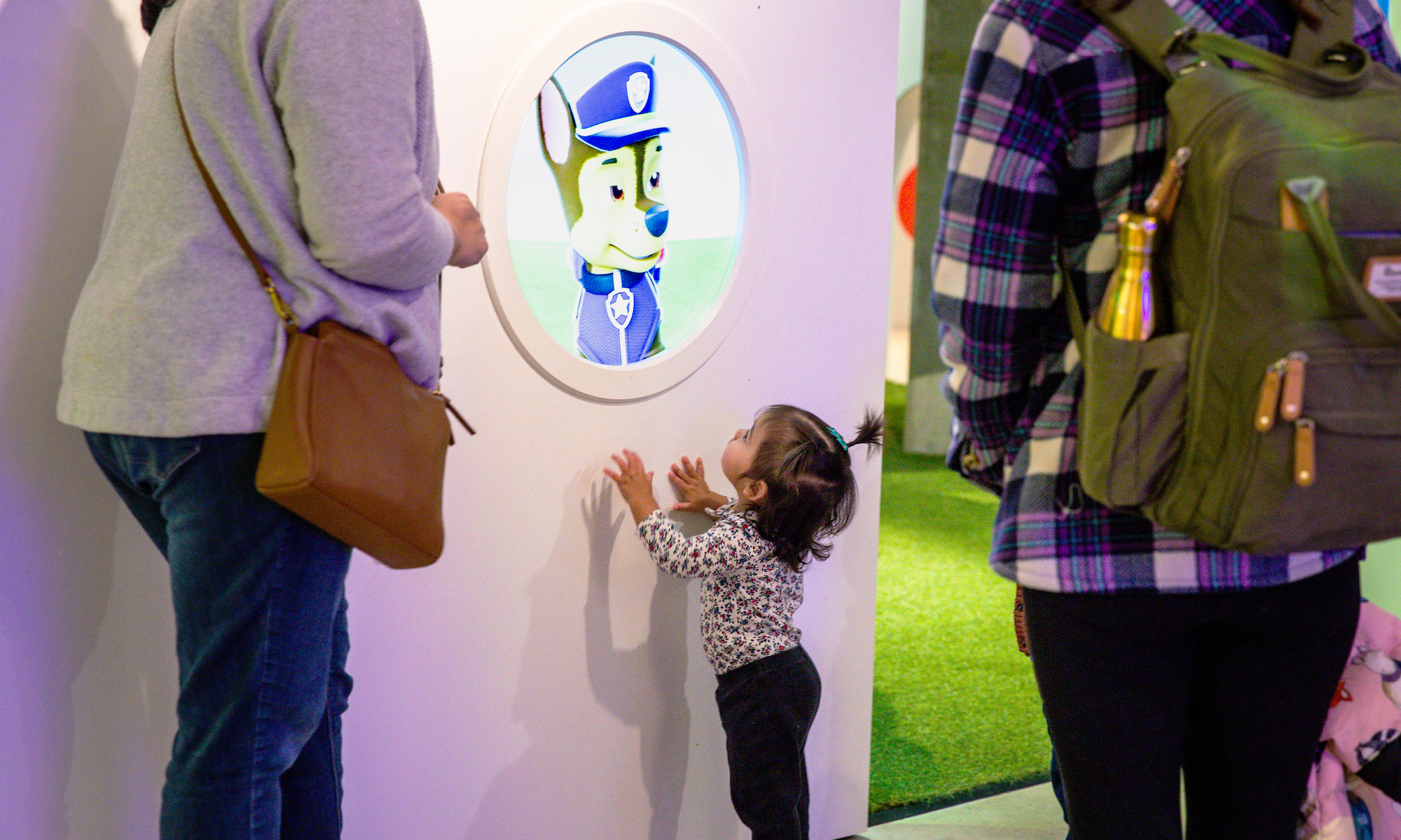 Little girl looking at a paw patrol character in the Art + Tech exhibit