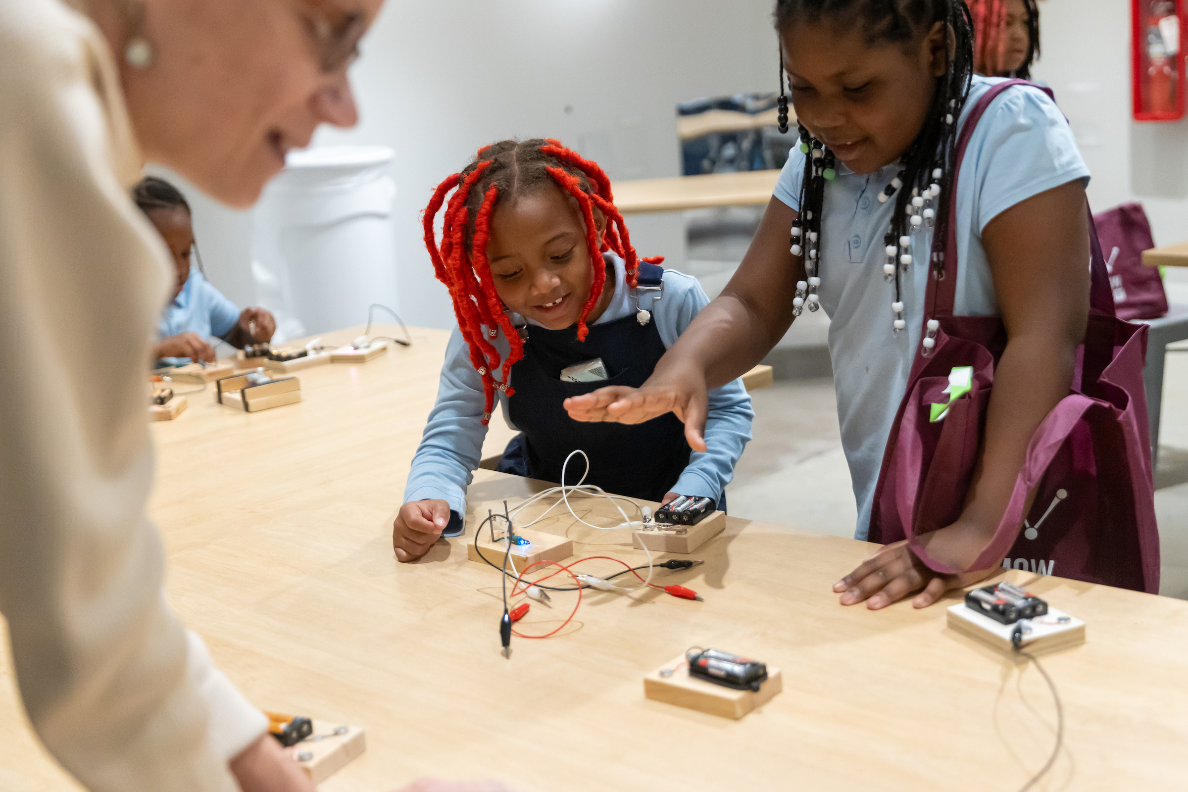 Two young girls participating in field trip programming in the Tinkerers Studio